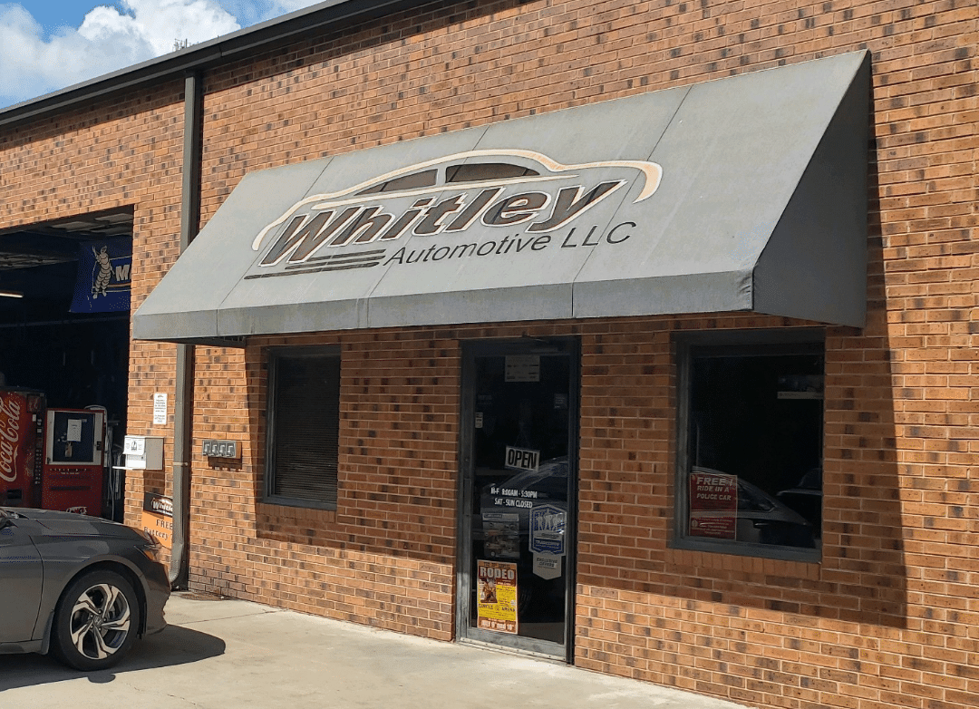 Front door and signage of Whitley Automotive auto repair in Marshville, NC.