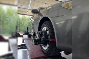Car maintenance, auto repair in Locus, NC by Whitley Automotive. Image of a vehicle positioned on an alignment rack with precision alignment sensors attached to the wheel, highlighting accurate wheel alignment, improved tire wear, and safe vehicle handling.