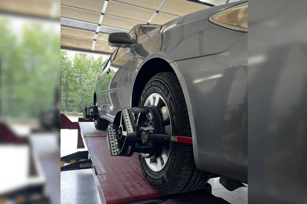Car maintenance, auto repair in Locus, NC by Whitley Automotive. Image of a vehicle positioned on an alignment rack with precision alignment sensors attached to the wheel, highlighting accurate wheel alignment, improved tire wear, and safe vehicle handling.